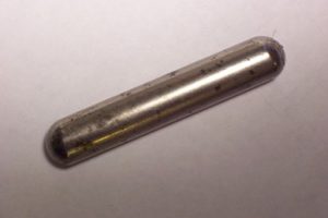 Photo of a cown magnet, a metal cylindrical capsule 