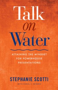 Talk on Water book cover - orange mottled background with title in white, red, and blue and a blue waver underneath.