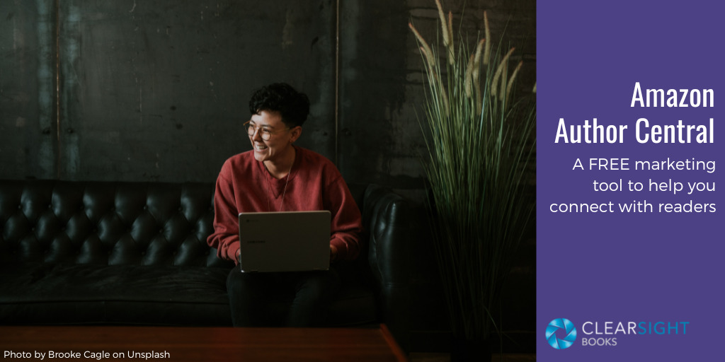 Person with laptop sitting on sofa, smiling at someone off camera