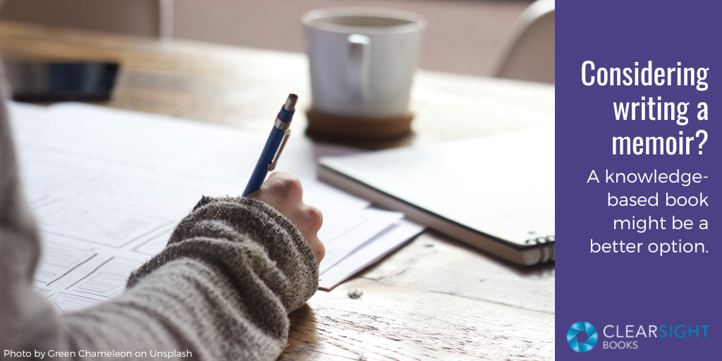 hand holding pen and writing, notebook and coffee cup in background. text: Considering writing a memoir? A knowledge-based book might be a better option.