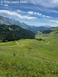 mountain view with a winding road through the valley