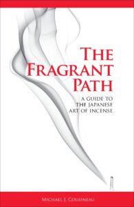 The Fragrant Path book cover: white background with red stripes across top and bottom; red text; a lit stick of incense at lower right, its smoke drifting up the page.