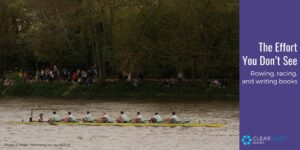 The Cambridge University men's 8 crew rowing past spectators on the shore with trees in the background. Text: The effort you don't see: rowing, racing, and writing books