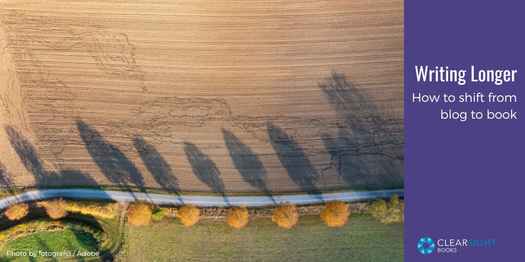 Birds-eye view of a road lined by trees with very long shadows reaching into a field. Text: Writing Longer: How to Shift from Blog to Book