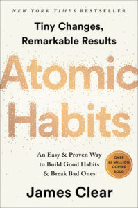 Atomic Habits book cover. The title is made up of gold dots (like atoms).